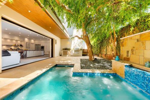 an indoor swimming pool with a tree in a house at Dolphin Sunset in San Diego