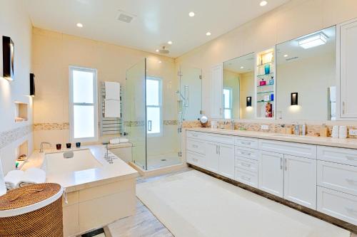 a bathroom with a tub and a shower and a sink at Dolphin Sunset in San Diego