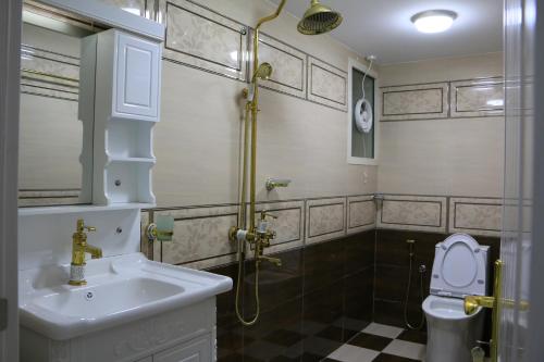 a bathroom with a sink and a shower and a toilet at Marina in Sohar