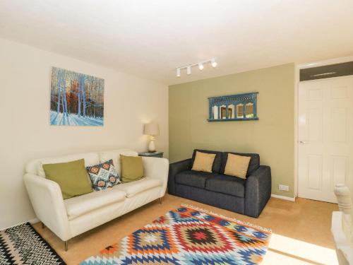 a living room with a couch and a chair at Beau Hideaway in Dorchester
