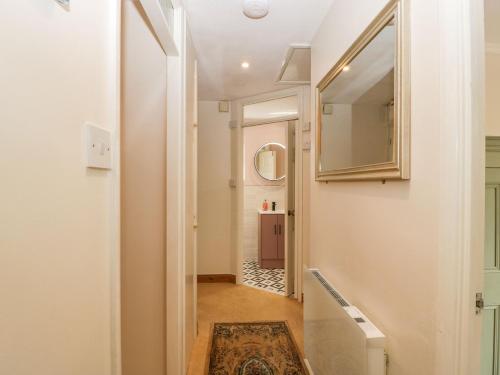 a hallway with a mirror and a rug at Beau Hideaway in Dorchester