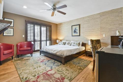 a bedroom with a bed and two red chairs at The Pearl of Park City in Park City