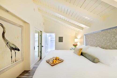 a bedroom with a large white bed with a tray on it at On The Beach Casita in San Diego