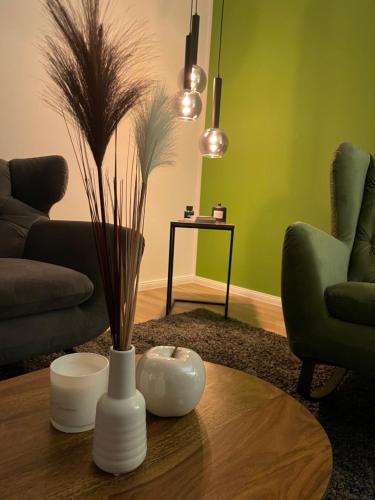 a living room with a white vase on a table at Ferien Bungalow Ennens in Rhauderfehn