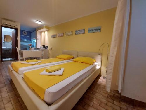 a bedroom with two beds with towels on them at Terra Apartments in Piran