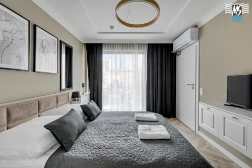 a bedroom with a large bed with two pillows on it at MS Apartments Rest 4.0 in Sopot