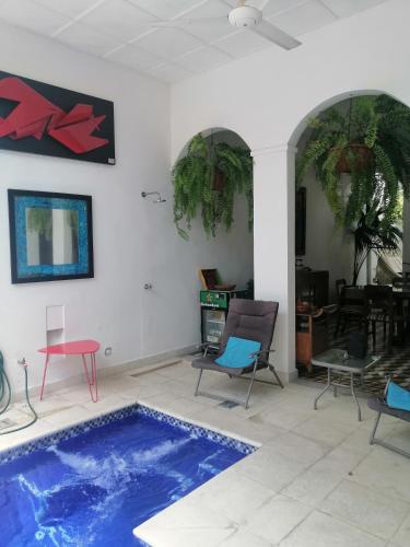 a living room with a swimming pool and chairs at Casa Paraiso in Honda