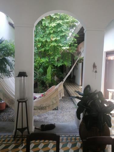 an archway in a building with a hammock in a room at Casa Paraiso in Honda