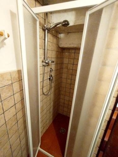 a bathroom with a shower with a door open at Borgo Antico - Torre Pugliola in Lerici