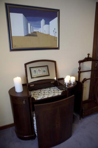 a room with a desk with a picture on the wall at Hotel Doña Jimena in Villarcayo