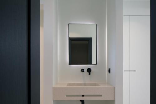 a bathroom with a sink and a mirror at Villa Kafkales Maleme - Heated Pool in Maleme