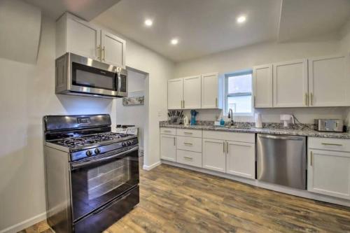 a kitchen with white cabinets and a stove top oven at Dunes Home 3 Bedroom I 2 Baths I 2 Living rooms in Chesterton