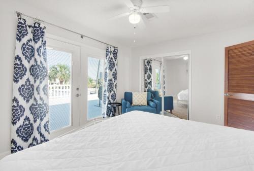 a bedroom with a bed and a blue chair at Makarios Beach Blu in Navarre