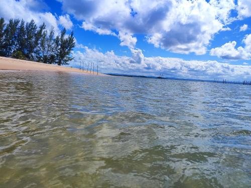 a body of water with trees and a beach at Pousada Pôr do Sol in Barra Grande