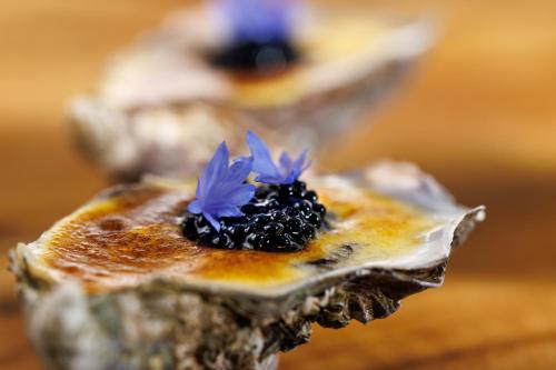 a piece of food with blue flowers on it at Boutique hotel Sies in Watervliet