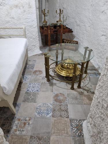 um quarto com uma mesa de vidro e uma cadeira em Casa rural El Parral em Bedmar