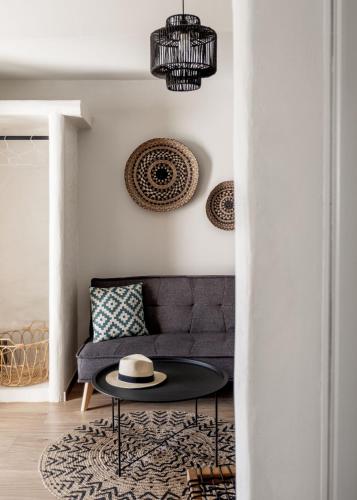 a living room with a couch and a table at Cactus Suites Kythnos in Mérikhas