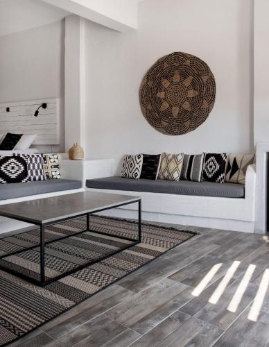 a living room with a table and a couch at Cactus Suites Kythnos in Mérikhas