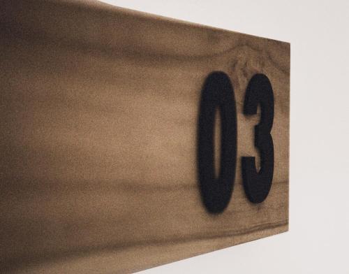 a wooden clock with the number eight on it at Cactus Suites Kythnos in Mérikhas