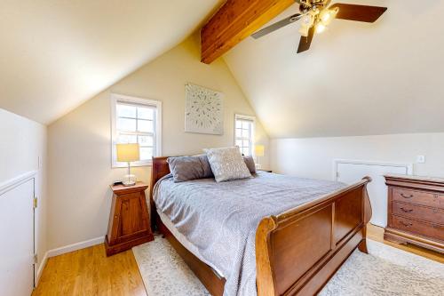 a bedroom with a bed and a ceiling fan at West Asheville Loft in Asheville