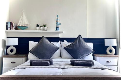 a bedroom with a blue and white bed with pillows at Farr Bay Inn in Bettyhill