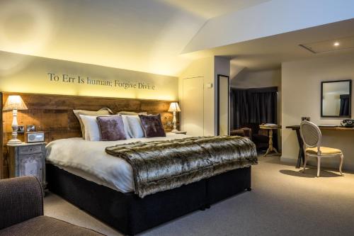 a hotel room with a large bed and a large window at The Alexander Pope Hotel in Twickenham