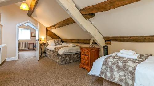 a bedroom with two beds in a attic at Forrest's Yard - Apartment 1 in Kendal