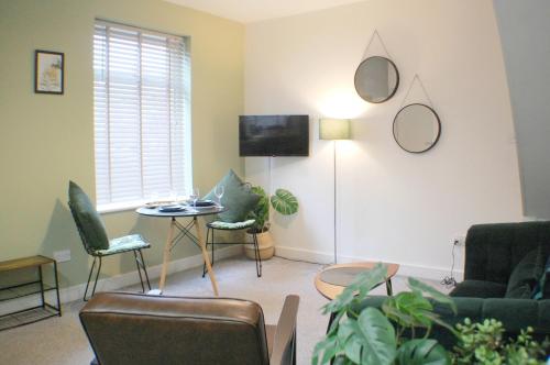 a living room with a couch and chairs and a table at Townhouse with private parking in York