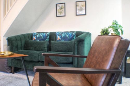 a green couch sitting in a living room at Townhouse with private parking in York