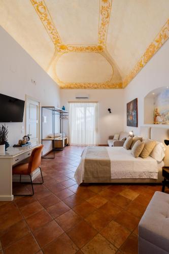 a large bedroom with a large bed and a ceiling at Corte Patitari - by Patitari Suites in Gallipoli