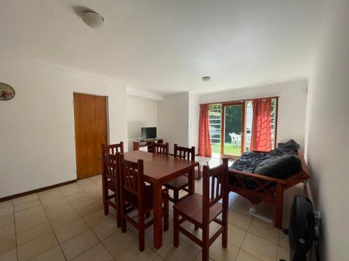 a dining room with a table and chairs and a couch at Casa Storni in Mar del Plata