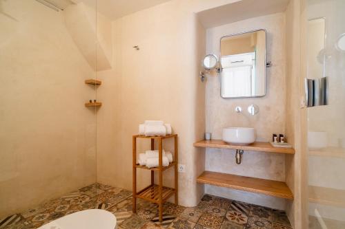 a bathroom with a sink and a mirror at Corte Patitari - by Patitari Suites in Gallipoli