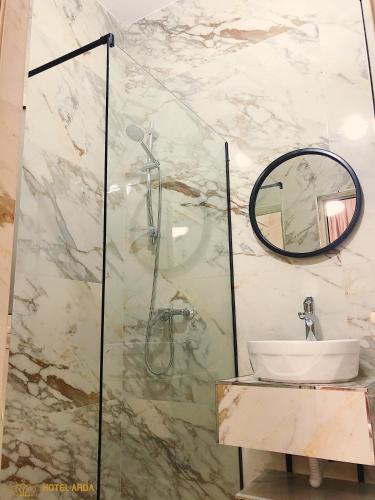 a bathroom with a sink and a glass shower at Hotel Arda Velipoje in Velipojë