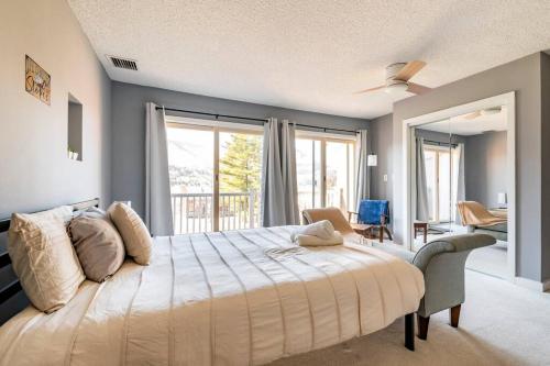 a bedroom with a large bed with a large window at Hunter Mountain Ski House - A Cozy Retreat by the Slopes in Hunter