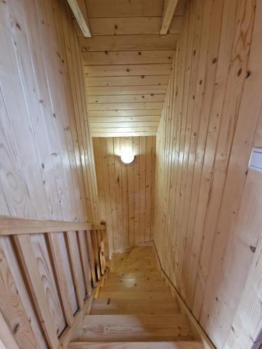 a wooden sauna with a wooden floor and a light at Domki pod Jaworem Brenna in Brenna