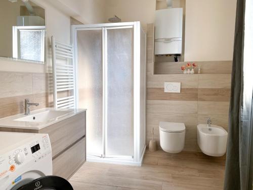 a bathroom with a shower and a toilet and a sink at Monolocale San Guido in Acqui Terme