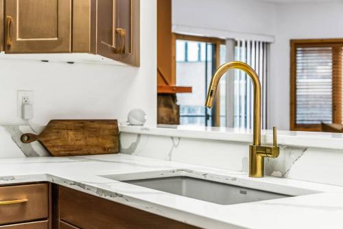 a kitchen with a sink and a counter top at Luxe Deer Valley Condo in Park City