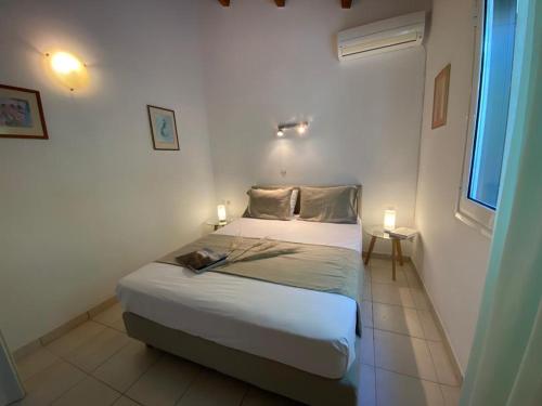 a bedroom with a bed with two candles on it at Glyfada Seaview 126 in Glyfada