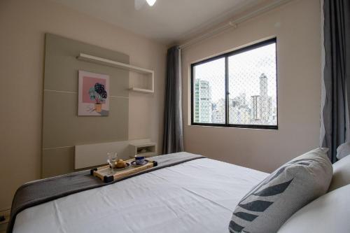 um quarto com uma cama grande e uma janela em BK91 - Próx Calçadão, Sacada, 3 Dorm, Garagem em Balneário Camboriú