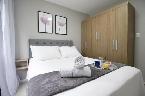 Un dormitorio con una cama con una bandeja de comida. en BRC71 - Quadra Mar, Lindo Espaço, Churrasq, Sacada, en Balneário Camboriú