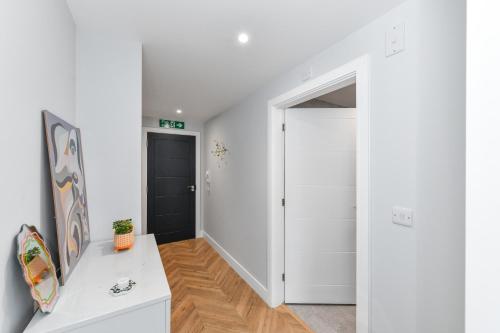 a hallway with a white door and a white table at The Varsity Studios in Nottingham