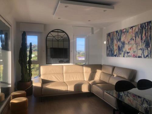 a living room with a couch and a window at Apartamento 3 habitaciones Miramar, Luanco in Luanco