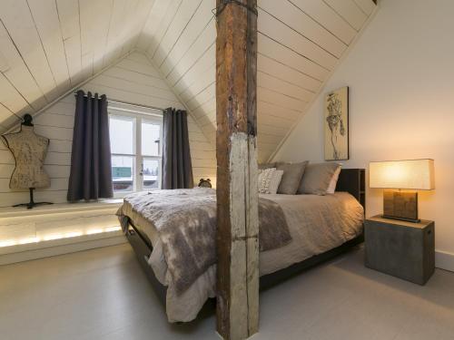 a bedroom with a large bed in a attic at 338 - Le Quai des Veuves - Les Immeubles Charlevoix in Baie-Saint-Paul
