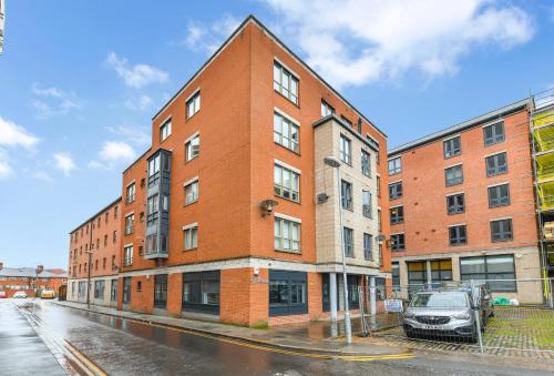 a brick building with a car parked in front of it at The Varsity Studios in Nottingham