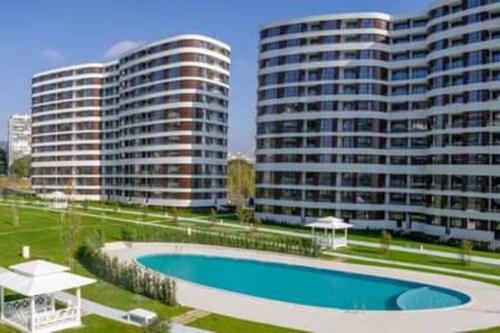 a swimming pool in front of two tall buildings at Beautiful Apartment with year round hot mineral pool and jakuzi in Varna City