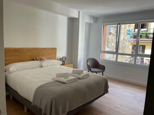 a bedroom with a bed with two towels on it at IZARRA by Smiling Rentals in Hondarribia