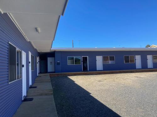 un edificio vacío con un edificio azul en The Frontier Motel, en Dorrigo