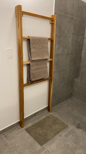 a bathroom with a towel rack in a shower at Bahía Santamaría in Moñitos