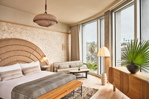 a bedroom with a large bed and a large window at Santa Monica Proper Hotel, a Member of Design Hotels in Los Angeles