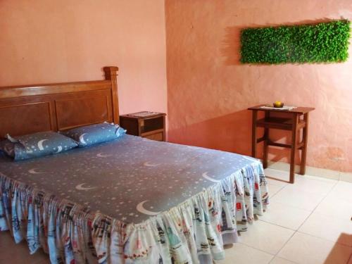 a bedroom with a bed with a bed skirt on it at La Ponderosa in Asuncion